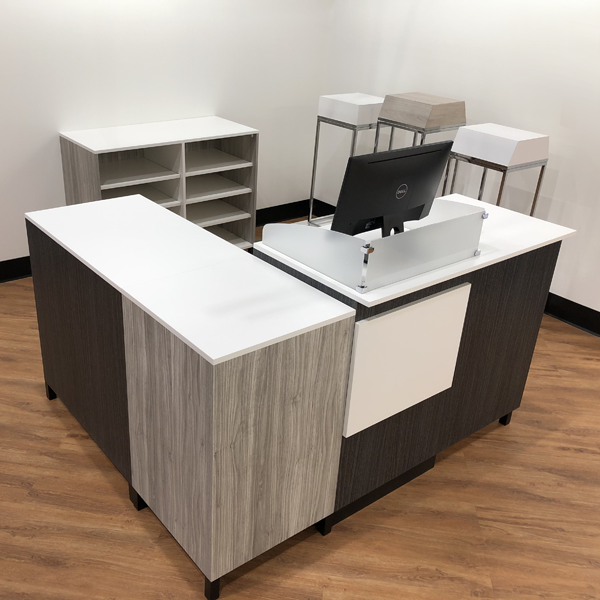 A live photo of the 4 foot cash desk in action, alongside 2 cash wraps and a corner filler