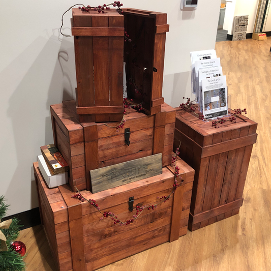 The rustic crate series 400 with a crimson stain set up as a christmas holiday display. Cranberries surround an acrylic brochure holder